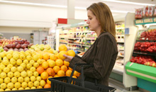 Photo of a woman shopping in the produce aisle of the grocery store