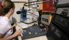 Photo of a member of the media operating audio/visual equipment